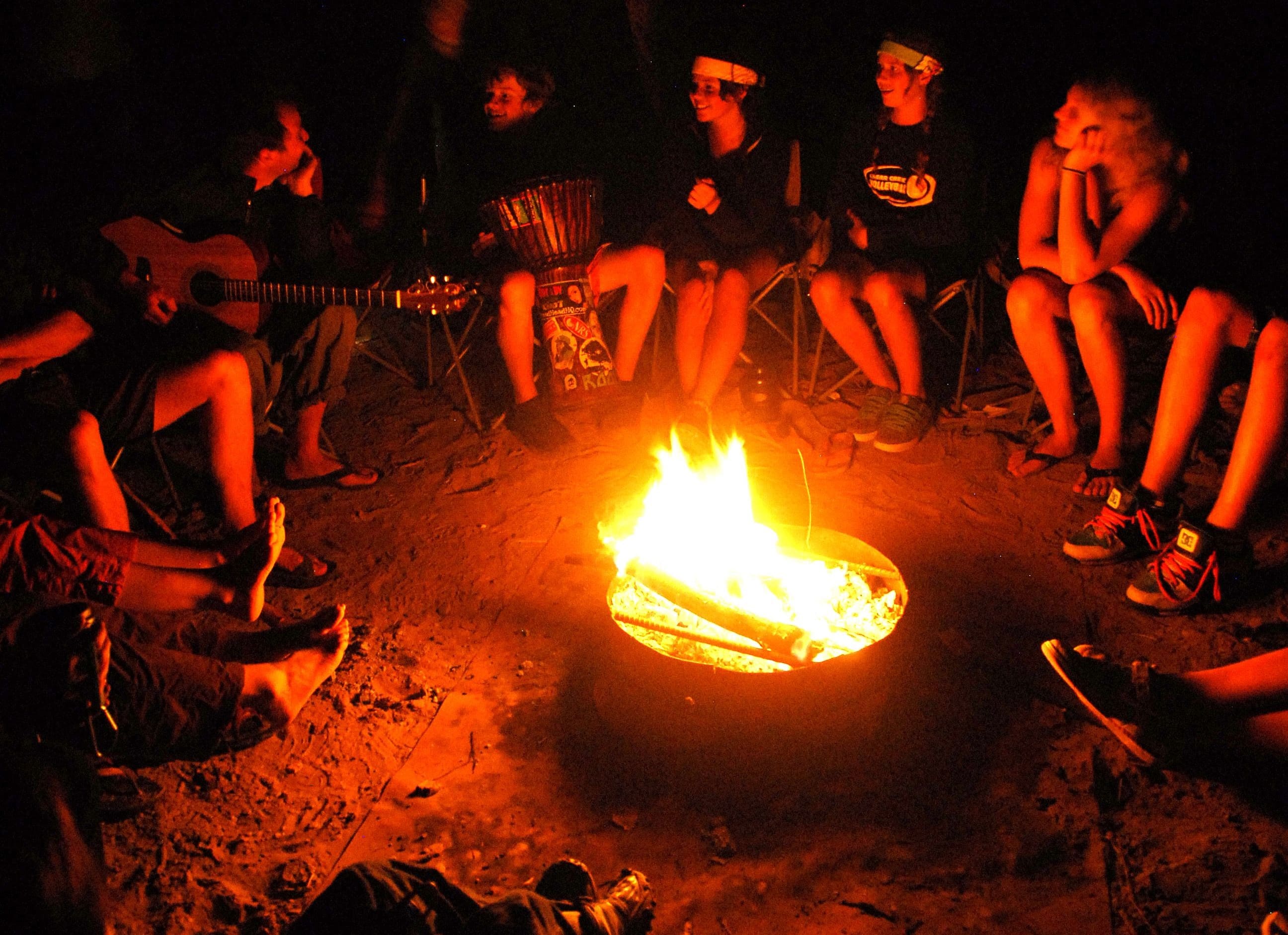 People sitting by the bonfire